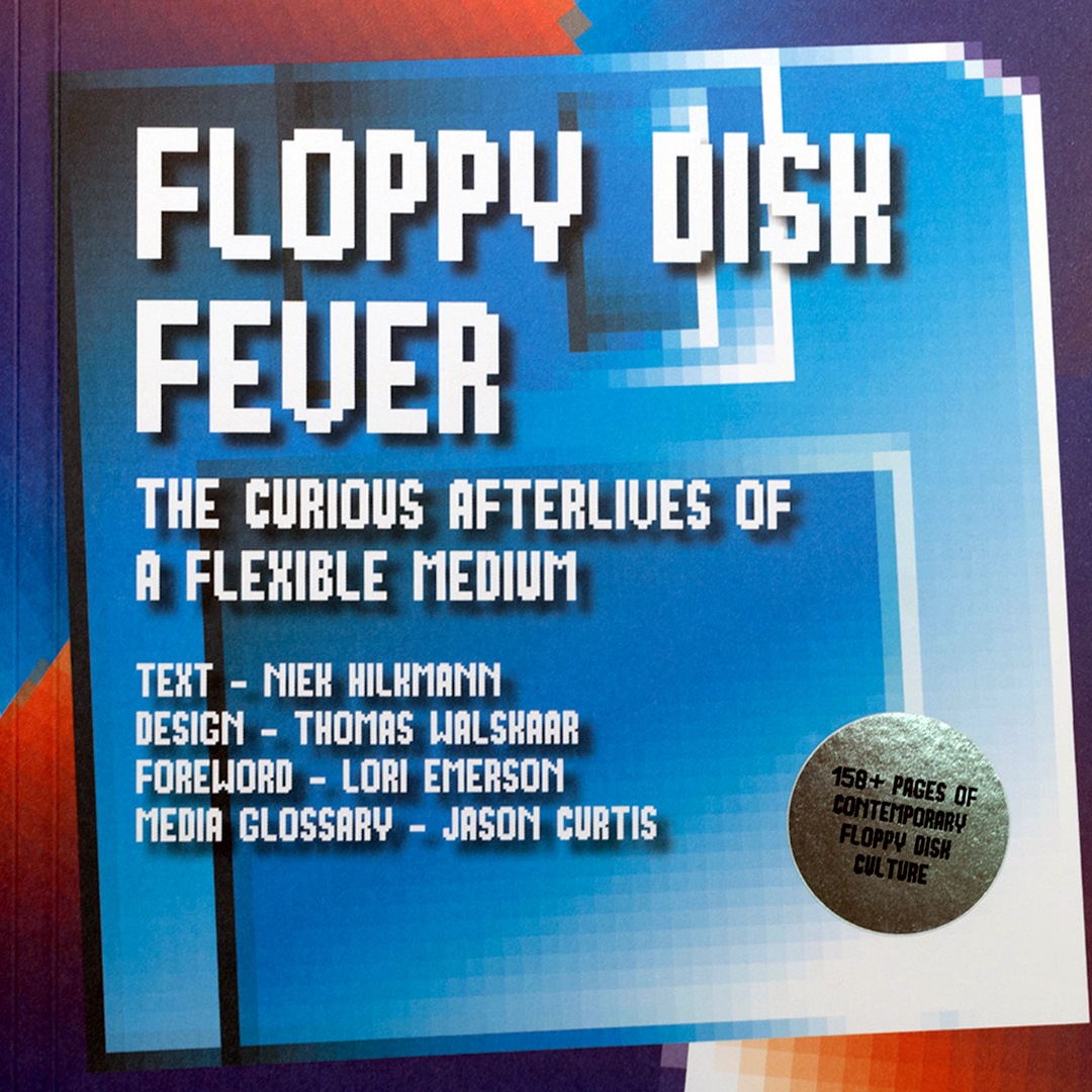 Book cover of 'Floppy Disk Fever: The Curious Afterlives of a Flexible Medium' by Niek Hilkmann, Thomas Walskaar, 2022. Blue/orange floppy disk icon is backdrop to 8-bit computer-y typeface text of the title. A golden seal sticker is affixed to the corner with words 158+ Pages of Contemporary Floppy Disk Culture. Photo provided by Onomatopee Projects.