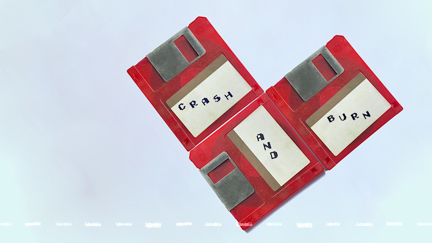 Three red 3.5-inch floppy disks sit on a white table arranged to form a heart shape. Their white labels have 8-bit text on them: CRASH AND BURN.